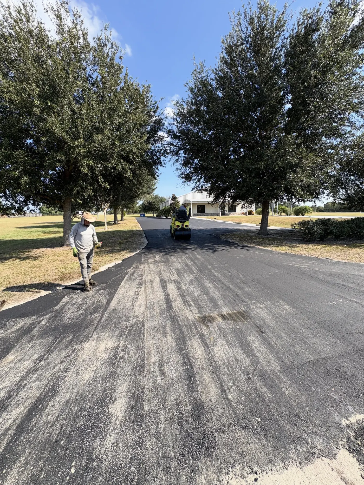 Long curving freshly paved driveway leading to a Montana home